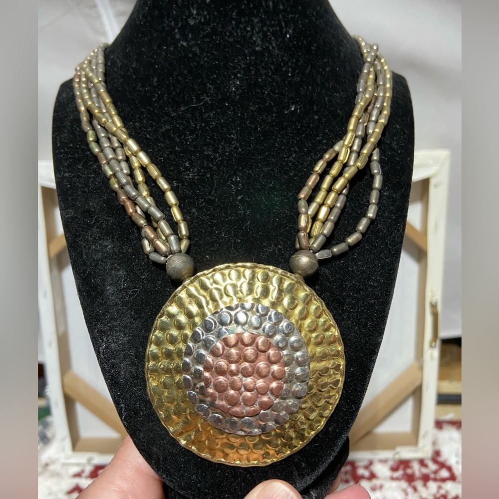 Pounded Metal Pendant, Beaded Necklace.  The Pendant Features 3 Metal Colors.